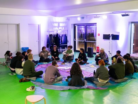 A group of people sitting in a circle.