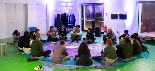 A group of people sitting in a circle.