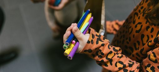 Child holding pens