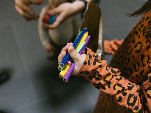 Child holding pens