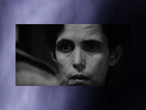 Crying person with dark hair