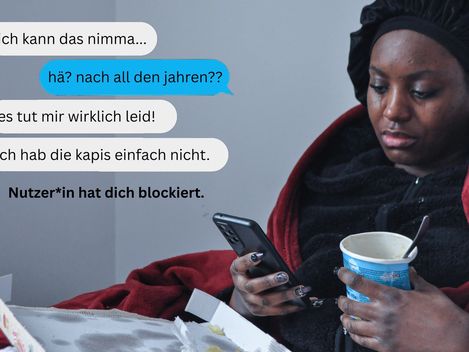 A person, wrapped in a blanket, is leaning against a wall, holding a mobile phone and an ice-cream sundae. They have been crying.