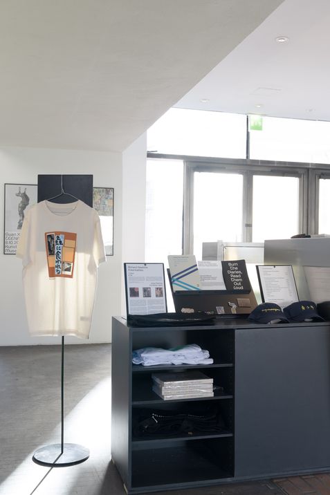 Interior view of the Kunsthalle Wien shop featuring a T-shirt display, art books, publications and merchandise at MuseumsQuartier Vienna.