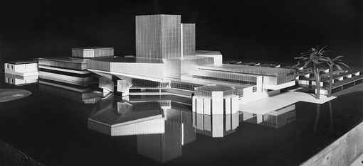 A model photo by Roland Rainer. A black background with several groups of light-colored buildings of varying heights.