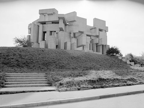 A black-and-white photograph of the Wotruba Church, made from concrete cubes.