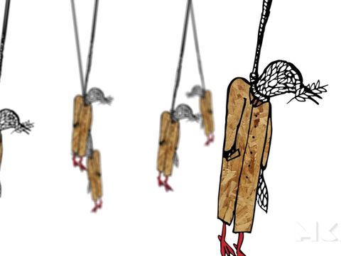 Several hanging wooden bird figures with netted heads and red feet on strings