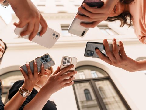 5 hands hold 5 phones