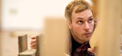 A person is trying to assemble individual components. With varying degrees of success.