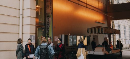 Some people are waiting in front of the entrance to Tanzquartier Wien.