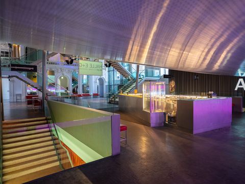 View of the inviting foyer of Hall E+G. The bar, staircases, and architectural combination of historical and modern elements can be seen.