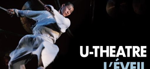 Dancer in white clothing leaps above a group of five drummers in traditional attire against a black background with the text "U-THEATRE L'ÉVEIL DE LA MONTAGNE".